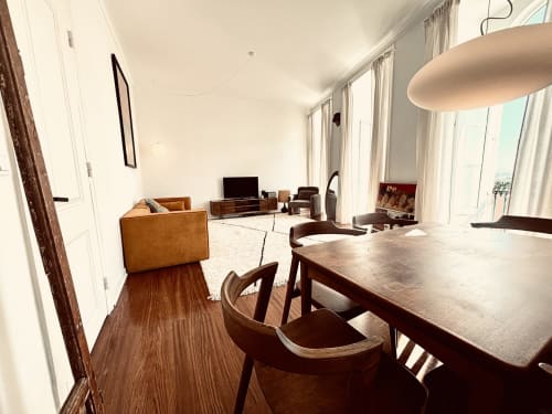 Modern dining area with wooden table and chairs in 6-bedroom apartment at Royal Prince Garden Apartments, Lisbon