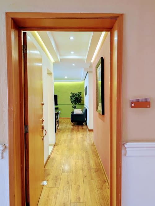Entrada del pasillo al Apt 6 del hotel Casa Donceles, Ciudad de México, con piso de madera e iluminación moderna