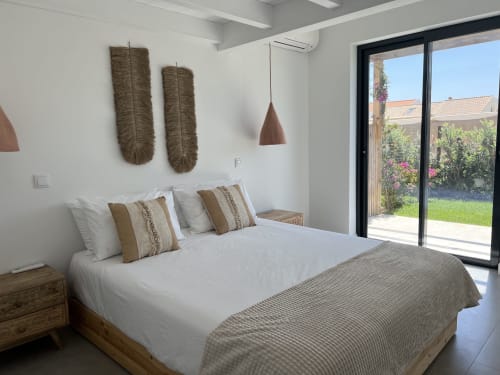 Modern bedroom at Star Host villa Casa Tonel in Bordeira with sea view, woven wall art, and garden access