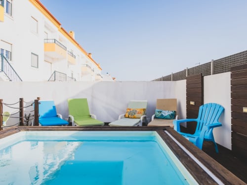 Private pool with blue loungers and white privacy wall at Baleal Beach Holiday Villa, Bombarral Portugal