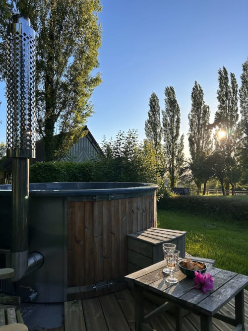 Hot tub with wooden deck at Domaine de Blanvatel, Saint Pierre en Auge, overlooking poplar trees and meadow