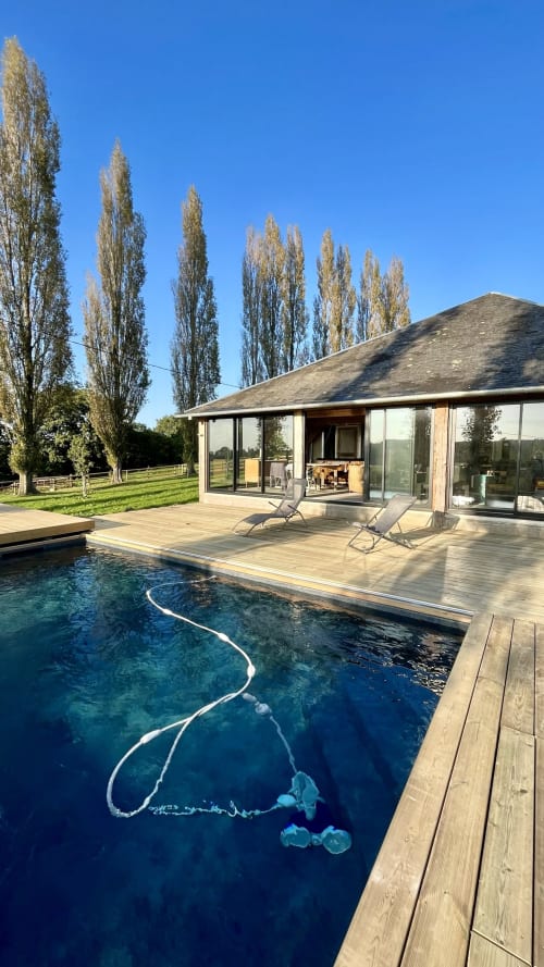 Domaine de Blanvatel pool and modern lodge in Saint Pierre en Auge with poplar trees and wooden deck