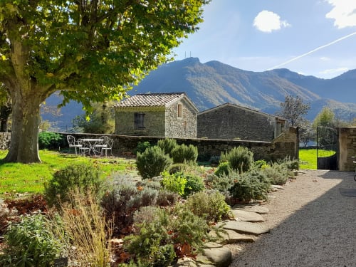 L'Amiradou B&B in Félines-sur-Rimandoule with stone buildings, gardens, and mountain views