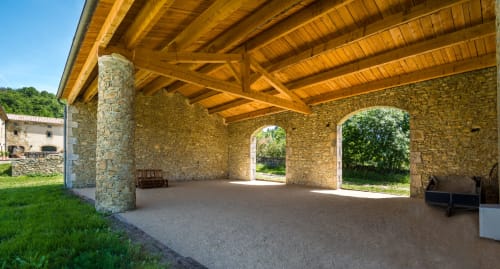 Stone covered pavilion with wooden beams at L'Amiradou B&B in Félines-sur-Rimandoule, France
