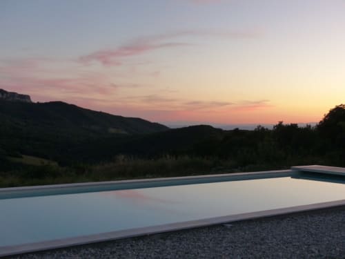 Infinity pool at L'Amiradou B&B overlooking Félines-sur-Rimandoule valley at sunset