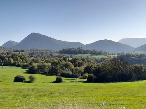 Rolling green meadows and mountains near L'Amiradou B&B in Félines-sur-Rimandoule, France
