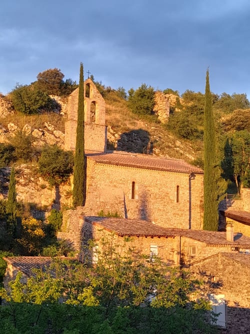 L'Amiradou stone chapel with cypress trees in Félines-sur-Rimandoule, France countryside