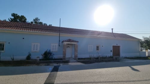 Blue and white villa exterior at Eco Charm Discovery Quinta da Oliveirinha in Leiria, Portugal with tiled roof and landscaped