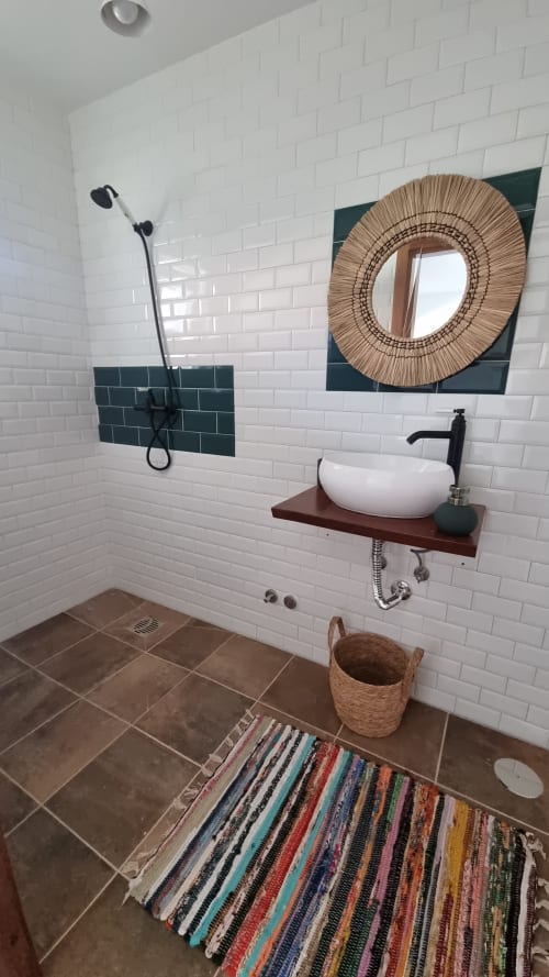 Modern eco-friendly bathroom at Charm Discovery Quinta da Oliveirinha villa in Leiria with white subway tiles, dark green
