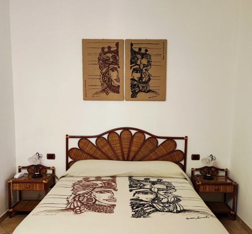 Camera moderna con testata letto a ventaglio in legno, copriletto artistico e decorazioni murali all'Hotel Principe di