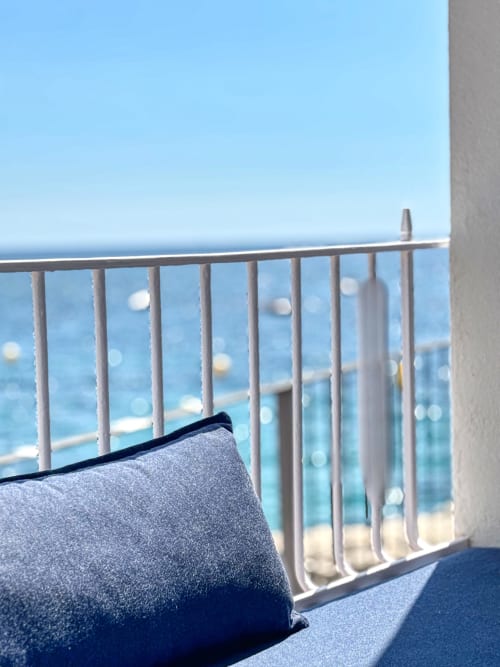 Beachfront balcony view at Finques Garcia Enrich hotel in Palafrugell with metal railing and sea vista