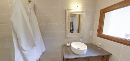 Modern bathroom at Aux Prés Du Berry B&B in Chavin with white vessel sink, mirror, and bright natural light