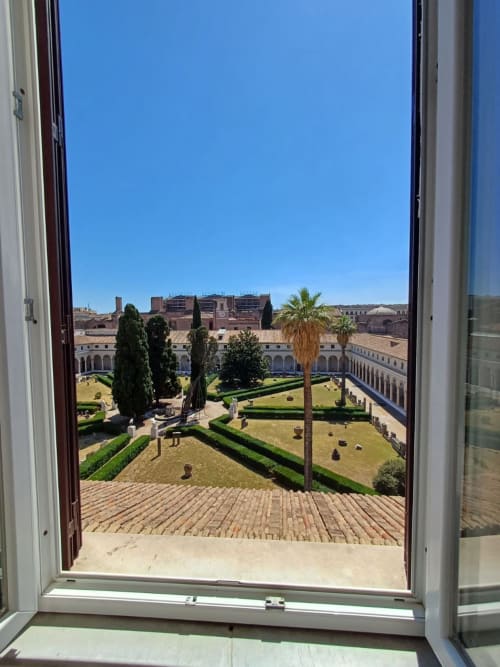 Vista giardino dalla Michelangelo Suite Roma con affaccio sulla corte piantumata di cipressi e palme a Roma