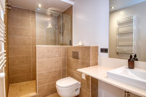 Modern bathroom with walk-in shower, double sink vanity, and heated towel rack at Finques Garcia Enrich apartment in