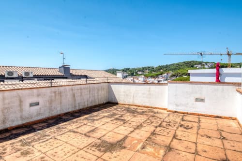 Rooftop terrace with terracotta tiles at Duplex apartment in Calella de Palafrugell, Spain