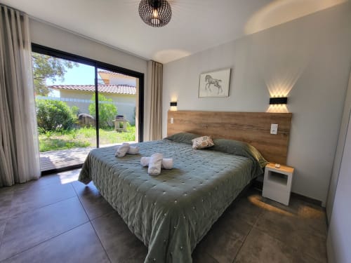 Modern bedroom at Villas Lantana B&B in Lecci with king bed, patio access, and contemporary decor