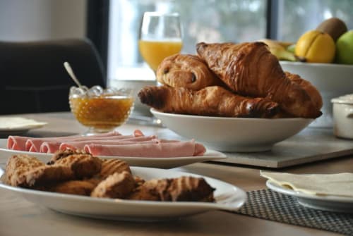 Petit-déjeuner raffiné à CARPE DIEM Résidence Hôtelière à Lorgues avec croissants, jambon et jus d'orange frais