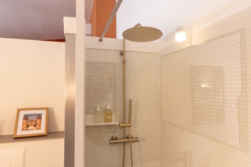 Modern bathroom shower with rainfall showerhead and brass fixtures in Charles Suite at Le Prieuré Notre-Dame, Montfrin