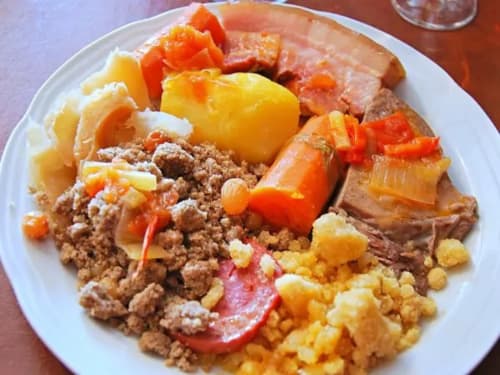 Colorful plate of mixed meat, potatoes, peppers, and corn at Espace Ker Gana B&B in Plourin, France