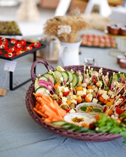 Colorful vegetable appetizers and skewers displayed at Espace Ker Gana buffet in Plourin