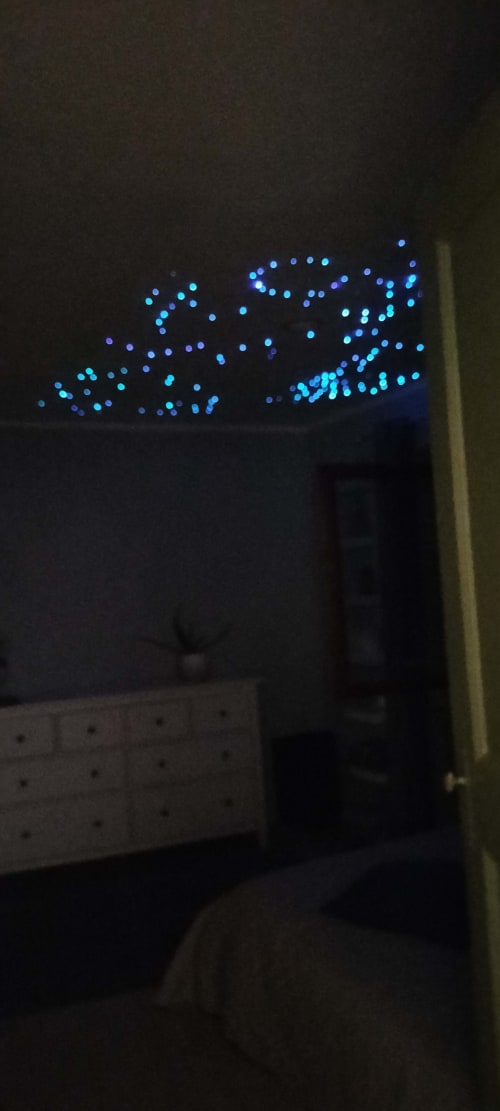 Glowing blue decorative lights in soul retreat bedroom at CasaRosada wellness B&B, Vidracco Italy