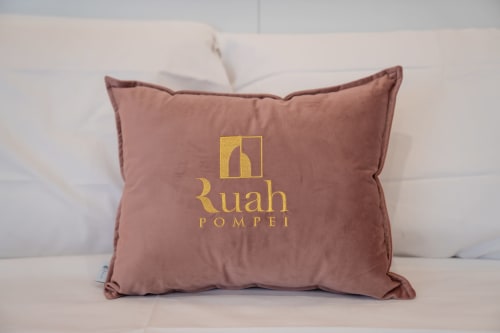 Ruah Pompei branded pillow on bed in Camera Tripla room at Pompei bed and breakfast