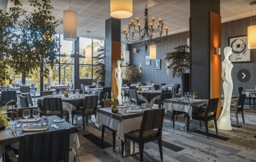 Restaurant gastronomique élégant à Home Horizon SBL à Limoges avec nappes noires, lustres modernes et