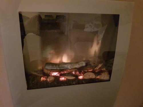 Electric fireplace with glowing logs and flames in Jane's B&B apartment No 27, Guisborough