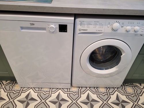 White Beko dishwasher and Indesit tumble dryer in Jane's B&B apartment laundry area, Guisborough