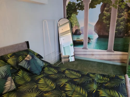 Modern bedroom at Jane's B&B Guisborough with tropical bedding, mirror, and scenic seaside mural view