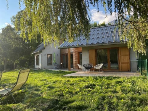 Locavilla villa in Colombes with mountain views, modern architecture, terrace, garden, and outdoor seating