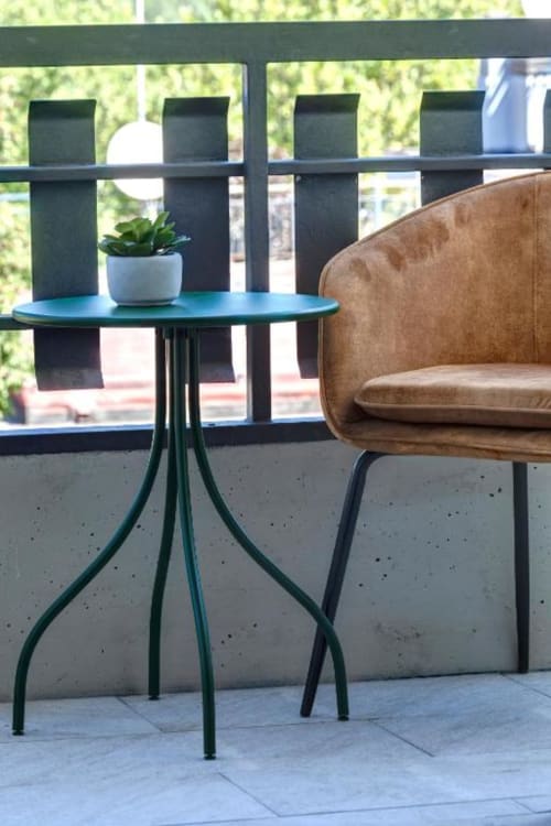 Balcony seating area at Palazzo Belvedere with turquoise table, tan chair, and potted succulent overlooking Chianciano Terme
