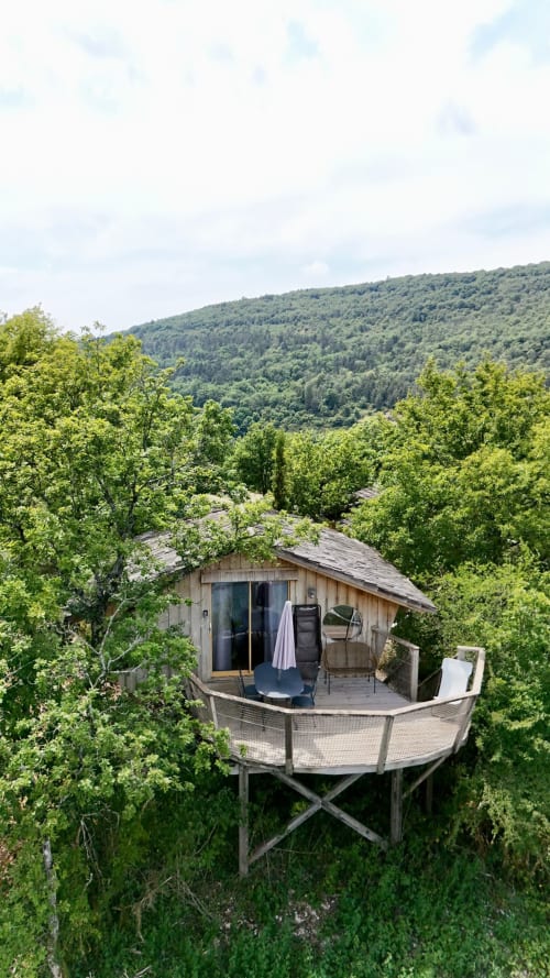 Cabina sugli alberi con terrazza spa che si affaccia sulle montagne boschive di Serrières-sur-Ain
