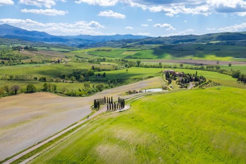 Tuscan countryside landscape with cypress-lined villa, rolling green hills and mountains near Chianciano Terme
