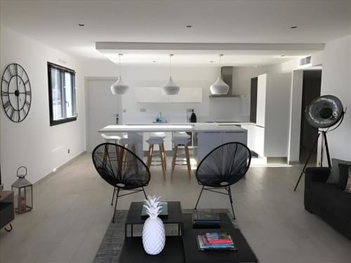 Cuisine ouverte moderne et séjour dans l'Apartment Elegance de Sweet Holiday, Porto-Vecchio, avec chaises noires et mobilier blanc
