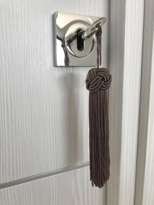 Chrome door lock with brown decorative tassel in Sweet Holiday apartment, Porto-Vecchio