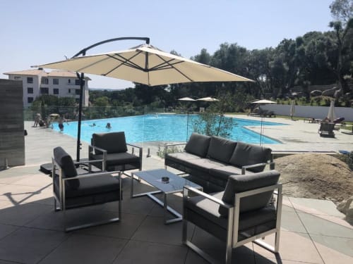 Poolside lounge area at Sweet Holiday in Porto-Vecchio with cantilever umbrella, outdoor seating, and swimming pool view