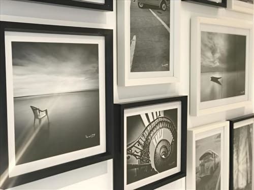 Gallery of framed black and white photographs displayed at Sweet Holiday hotel in Porto-Vecchio