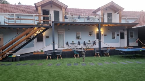 Modern villa with outdoor patio, dining area, and manicured lawn at Charm Discovery Quinta da Oliveirinha in Leiria, Portugal