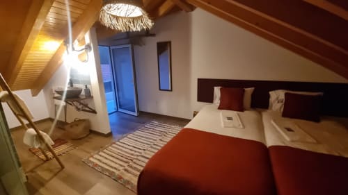 Modern villa bedroom at Charm Discovery in Leiria with king bed, balcony, desk, and contemporary décor