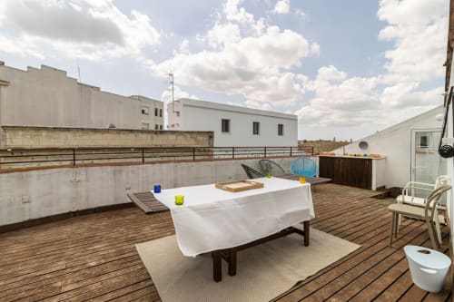 Terraza en azotea del apartamento Top Home Integra en Jerez de la Frontera con mesa de ping pong, tarima de madera y vistas a la ciudad