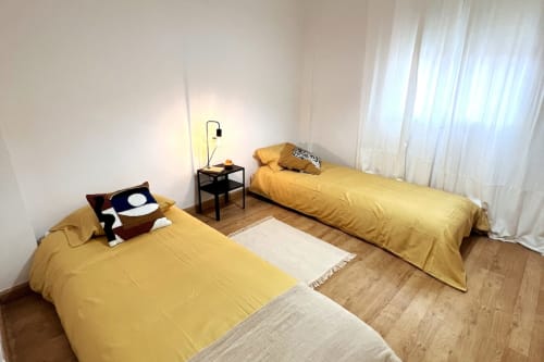 Dormitorio doble en apartamento Top Home Integra, Jerez de la Frontera con ropa de cama amarilla y suelo de madera