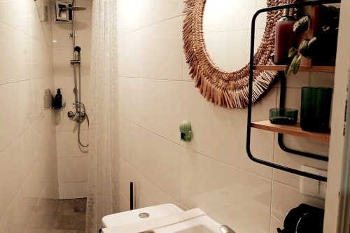 Baño moderno en apartamento Top Home Integra, Jerez de la Frontera, con ducha, espejo y detalles decorativos tejidos