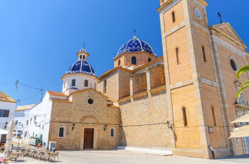 Altea's historic church with blue domes and bell tower in old town square, near Lemon Hostel
