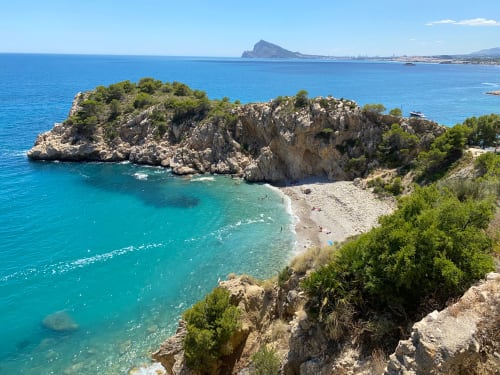 Rocky cove with turquoise sea near Altea, Spain, ideal for beach lovers visiting Lemon Hostel