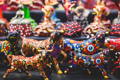 Colorful decorative bull figurines with vibrant floral patterns at Lemon Hostel Altea