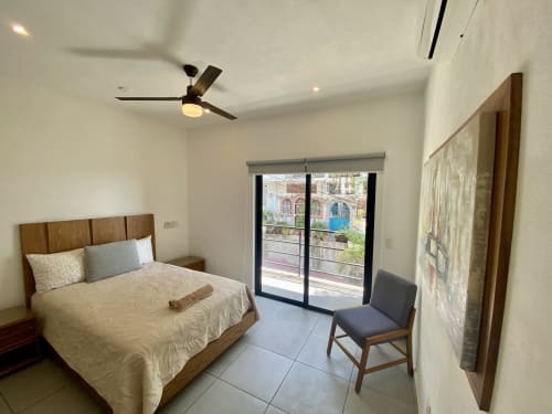 Anita Ocean View loft bedroom in Puerto Vallarta with sea view balcony, wood bed, ceiling fan, and modern amenities
