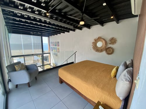 Anita Ocean View loft bedroom in Puerto Vallarta with sea view balcony, queen bed, modern furnishings, and exposed ceiling