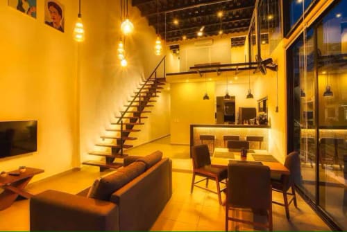 Modern loft apartment at Anita Ocean View, Puerto Vallarta featuring yellow walls, dining area, staircase, and furnished