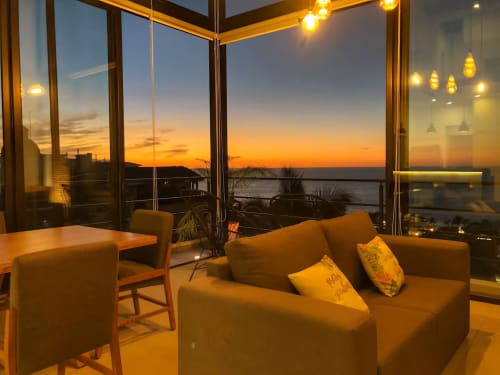 Sunset view from Anita Ocean View loft in Puerto Vallarta, modern seating area overlooking the bay at dusk